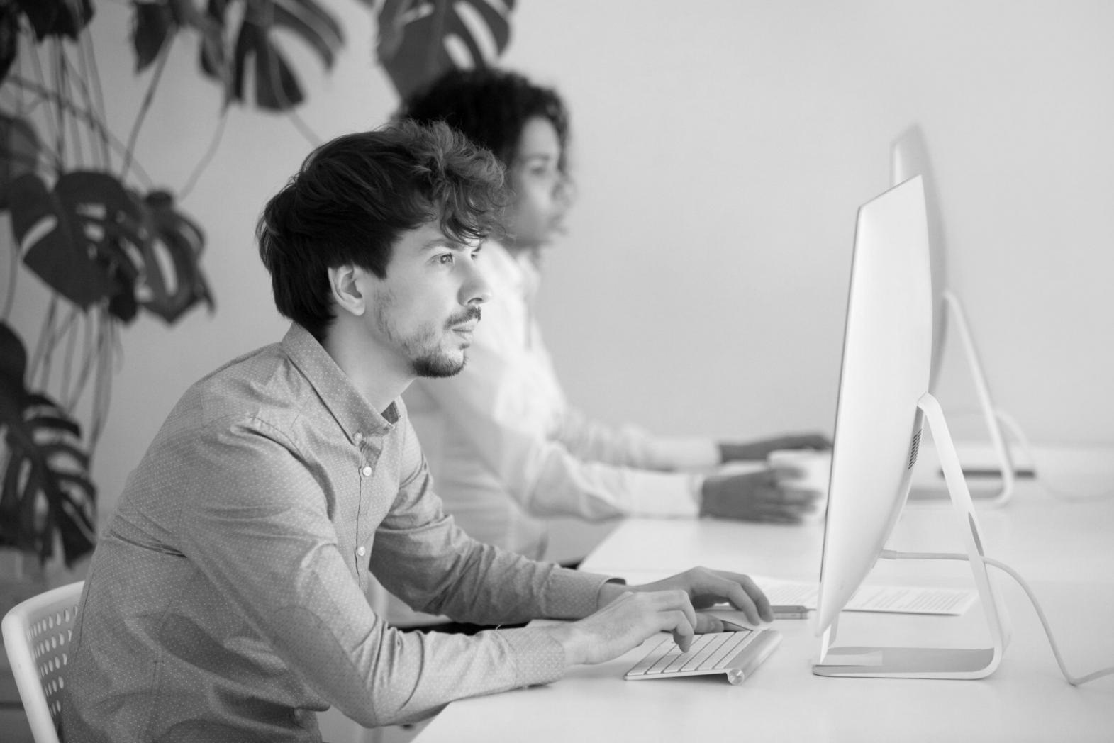 Development team reviewing game analytics and user engagement data on multiple screens
